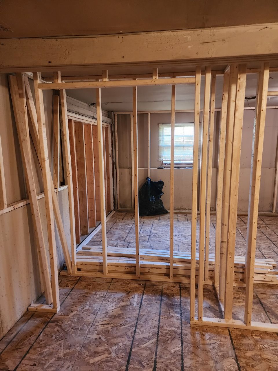 A room with a lot of wooden frames and a window.