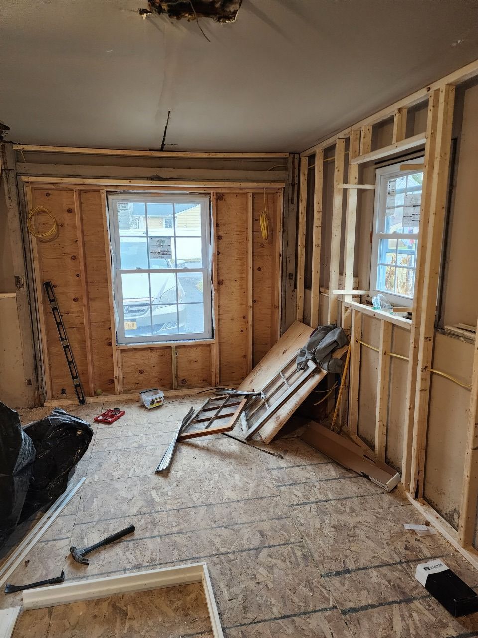 A room that is being remodeled with wooden walls and a window.