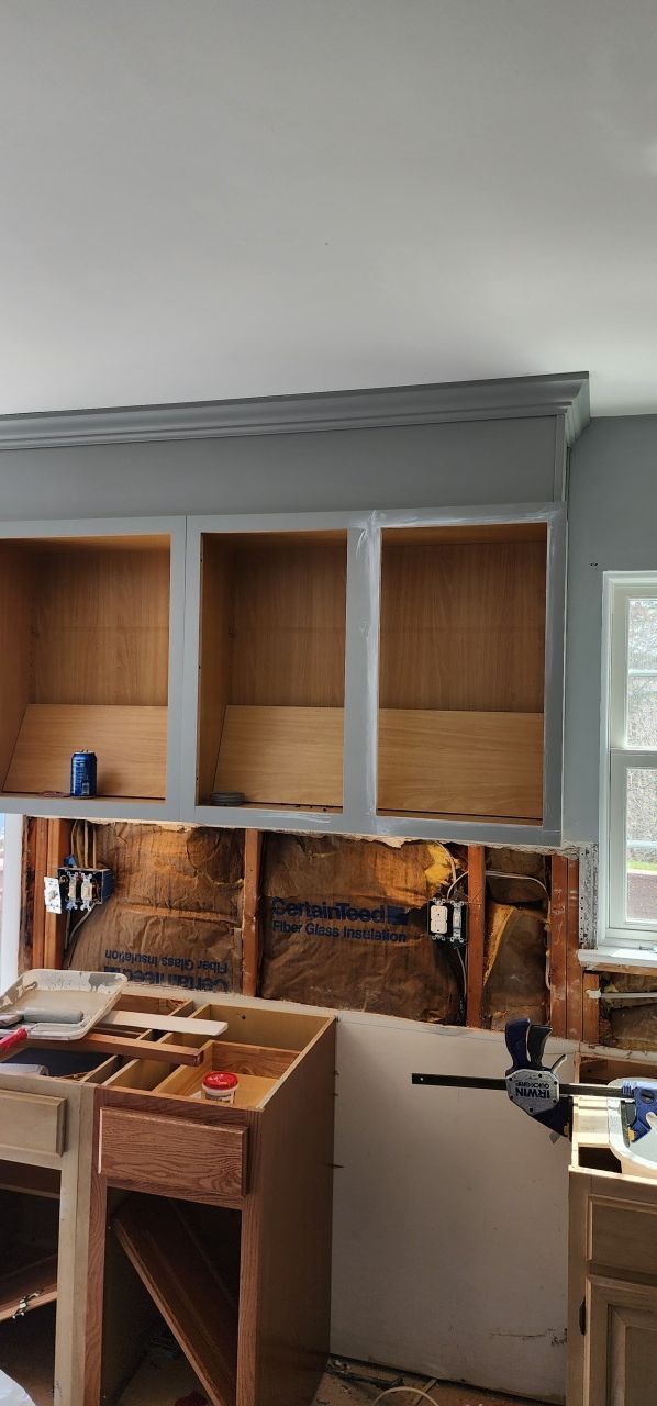 A kitchen cabinet is being built in a house.