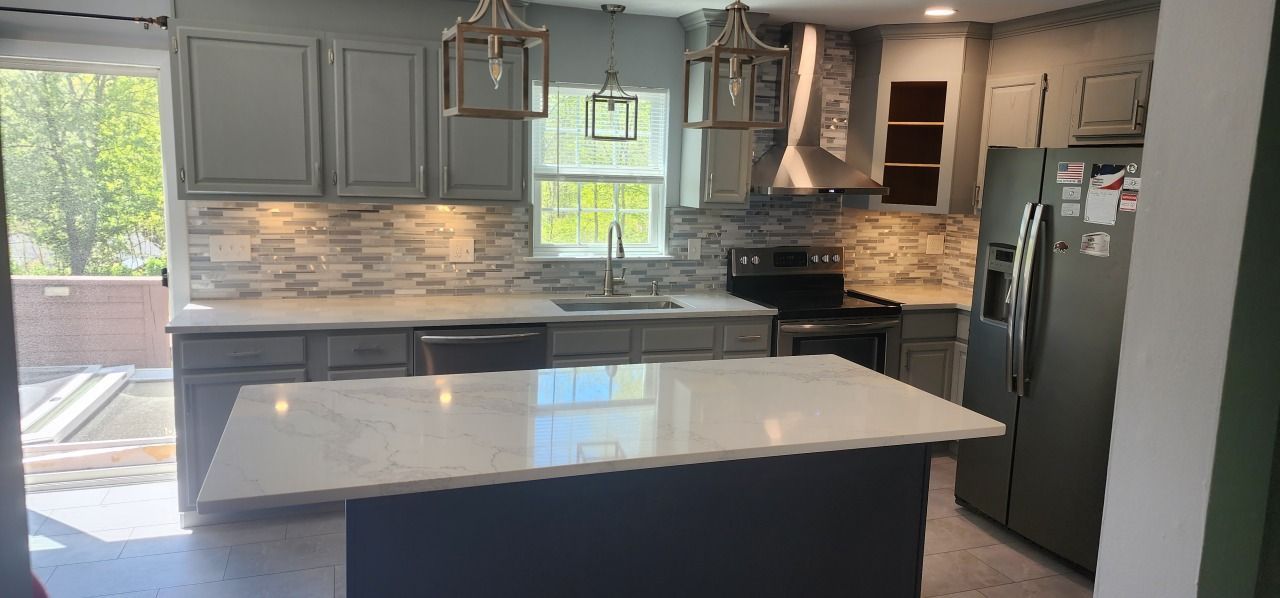 A kitchen with a large island in the middle of it.