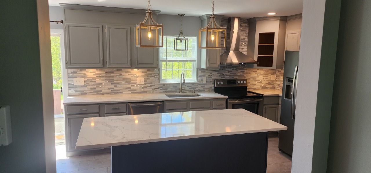 A kitchen with a large island in the middle of it.