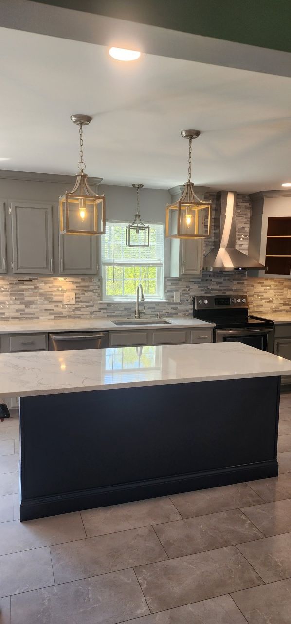 There is a large island in the middle of the kitchen.