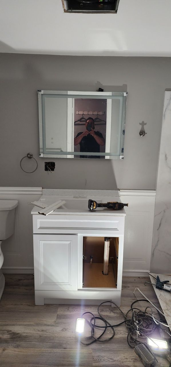 A bathroom with a sink , mirror and toilet.