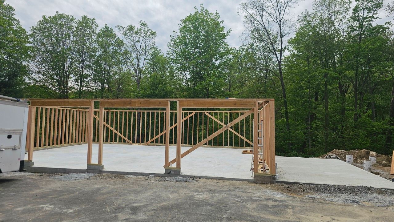 A wooden structure is being built in the middle of a forest.