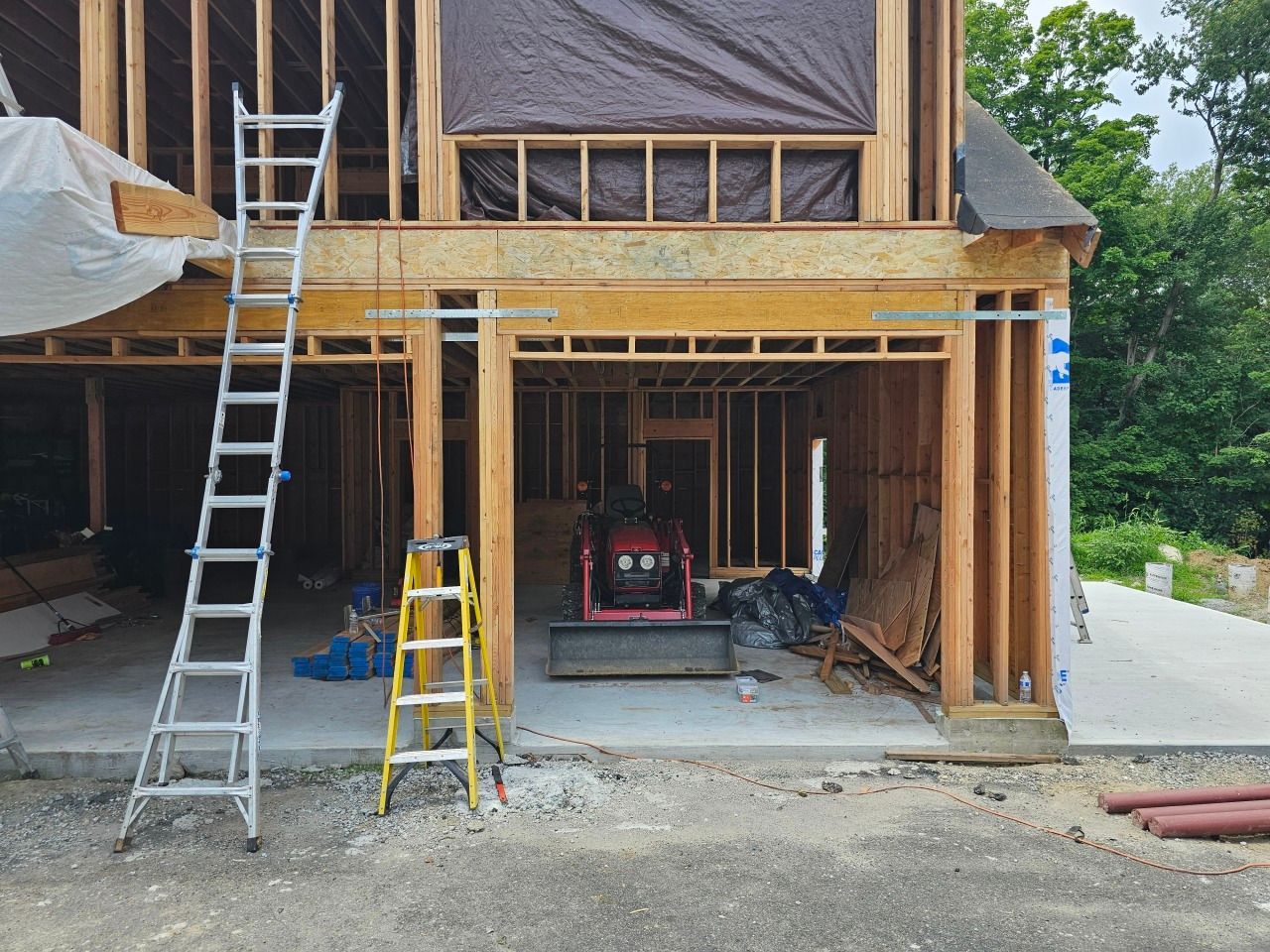A ladder is leaning against the side of a building under construction