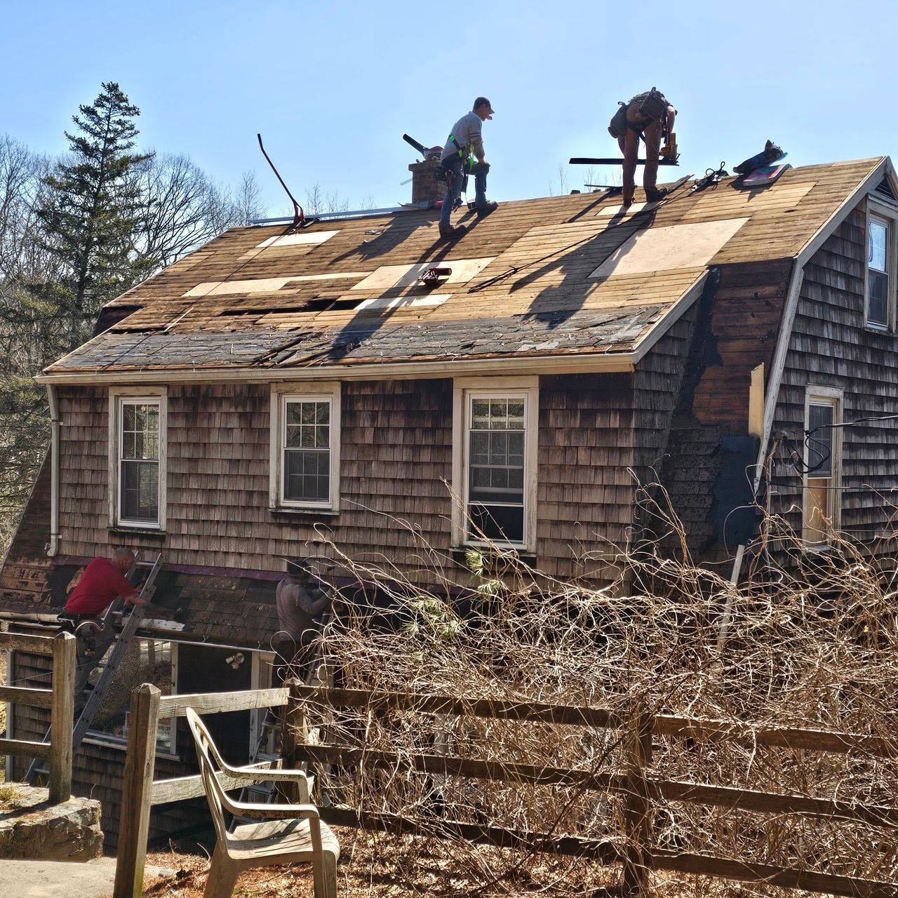 A man is working on the roof of a house