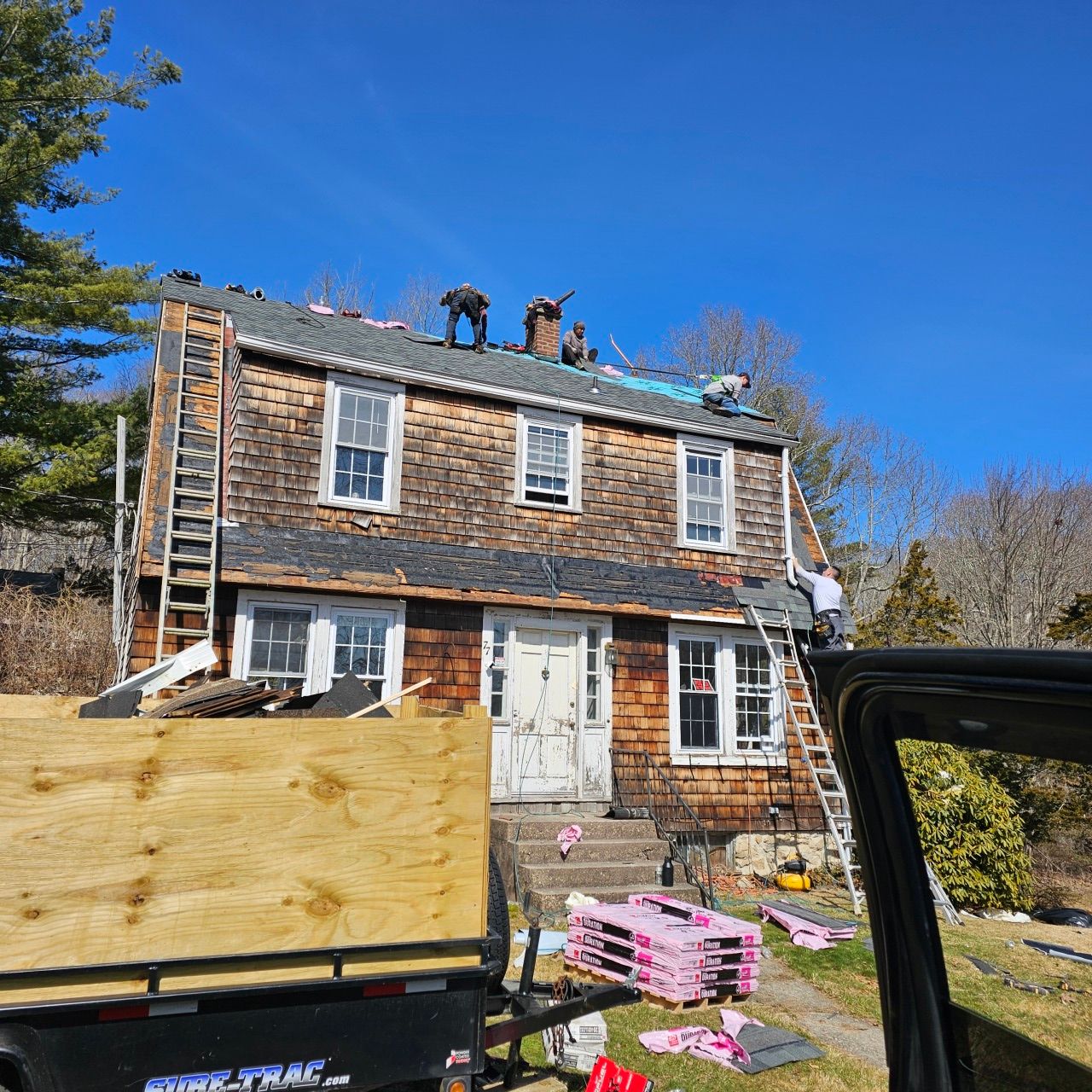 A truck is parked in front of a house that is being remodeled.