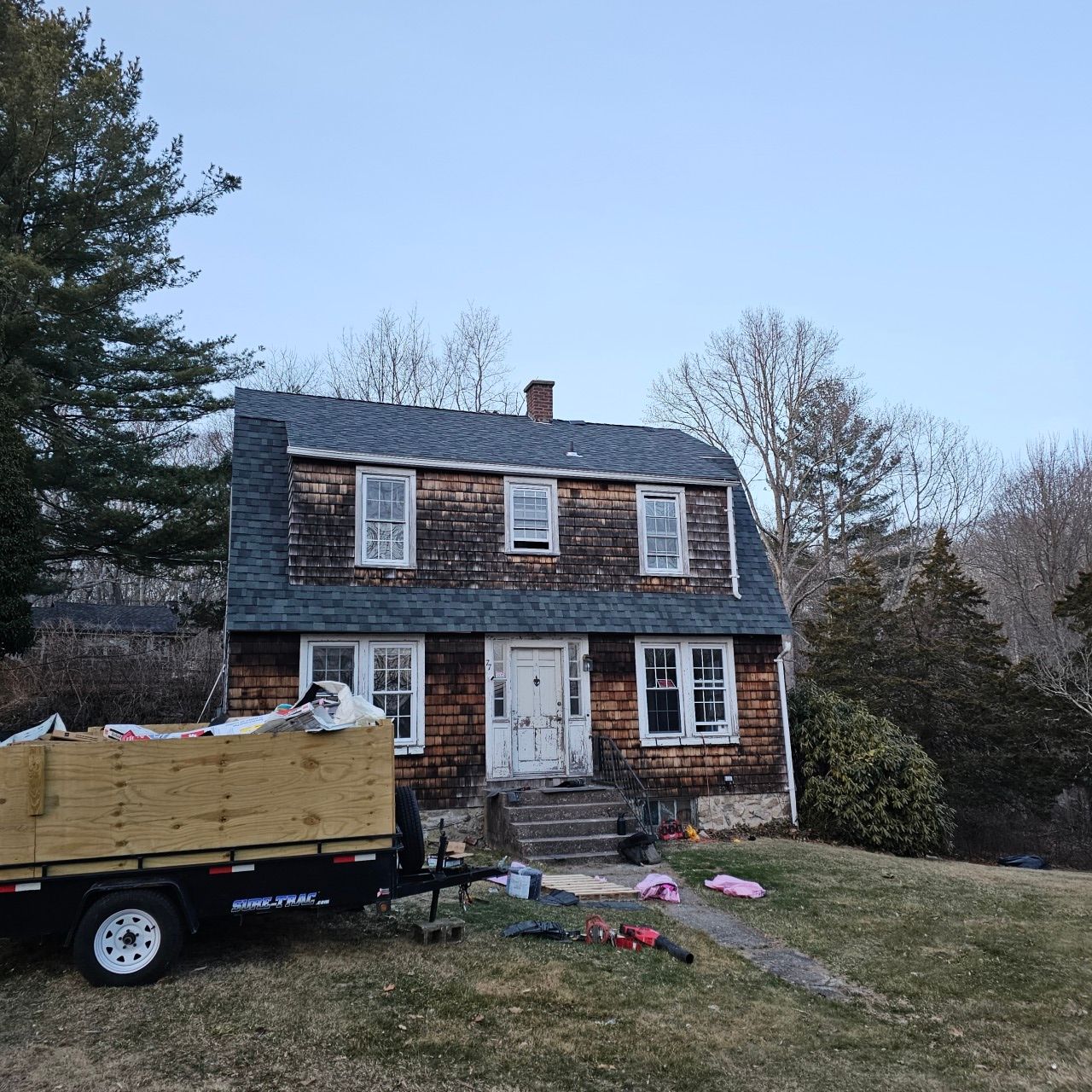 A house with a trailer parked in front of it