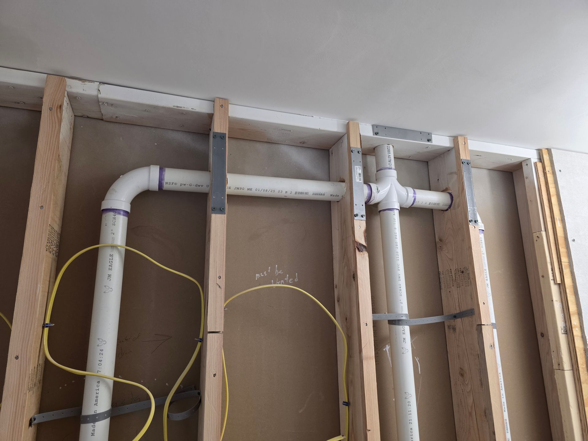 A wall with a bunch of pipes coming out of it