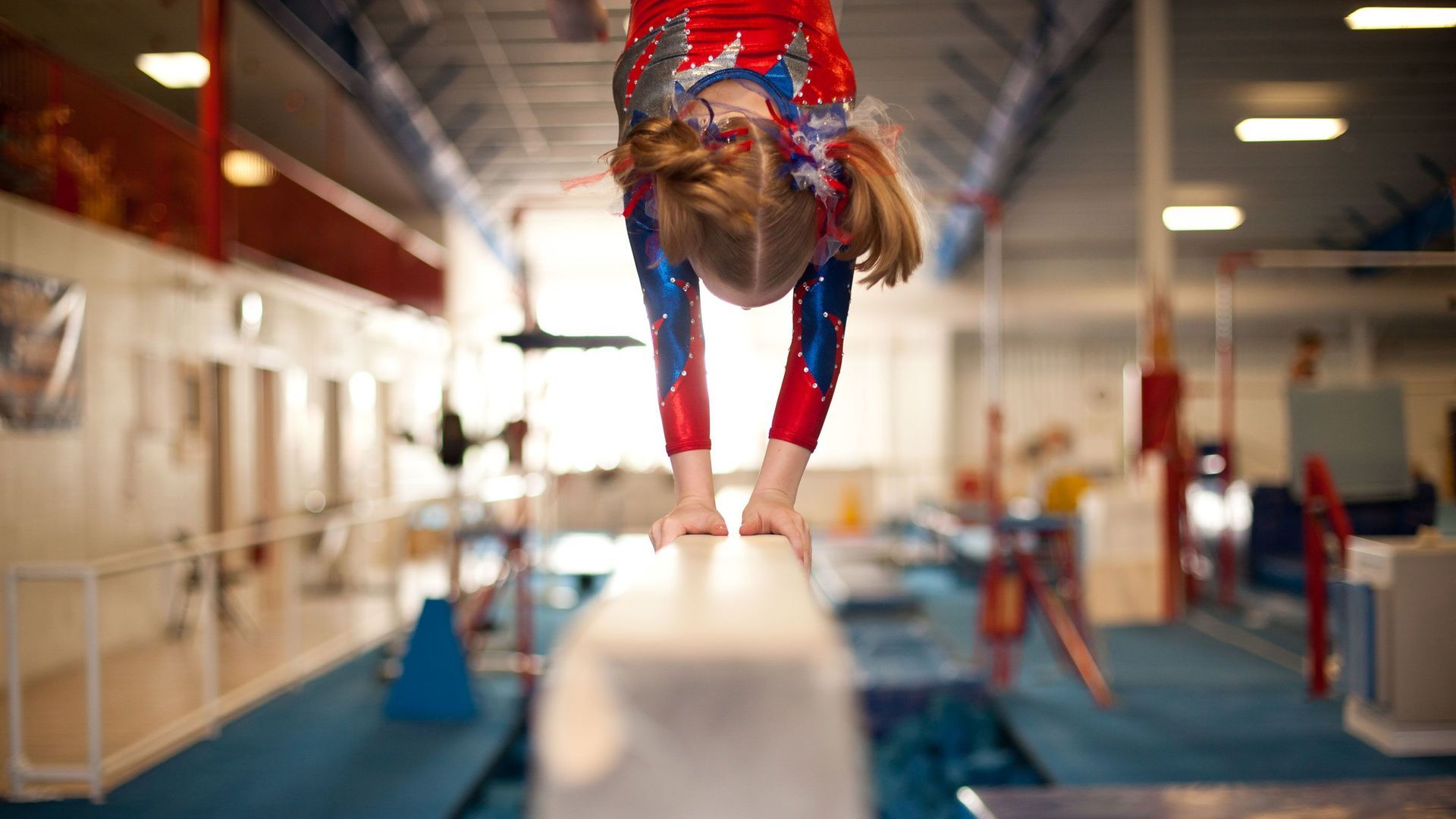 Young gymnast on the balance beam

