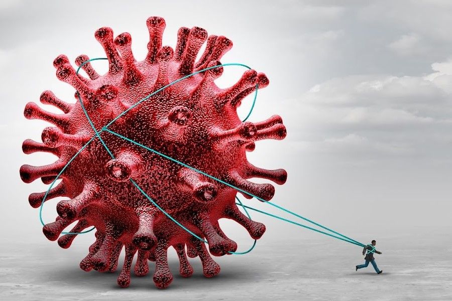 A man is pulling a large red virus with a rope.