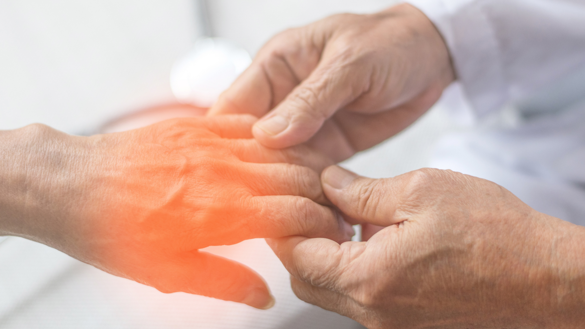 A close up of a person 's hand being examined by a doctor.