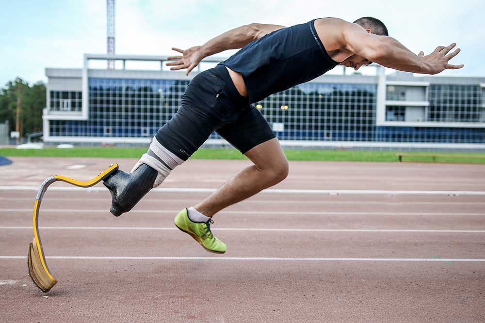 A man with a prosthetic leg is running on a track.