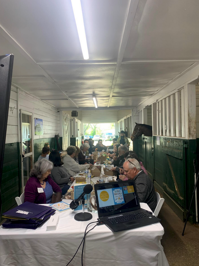 Speaking Engagement with a Large Table in a Horse Barn