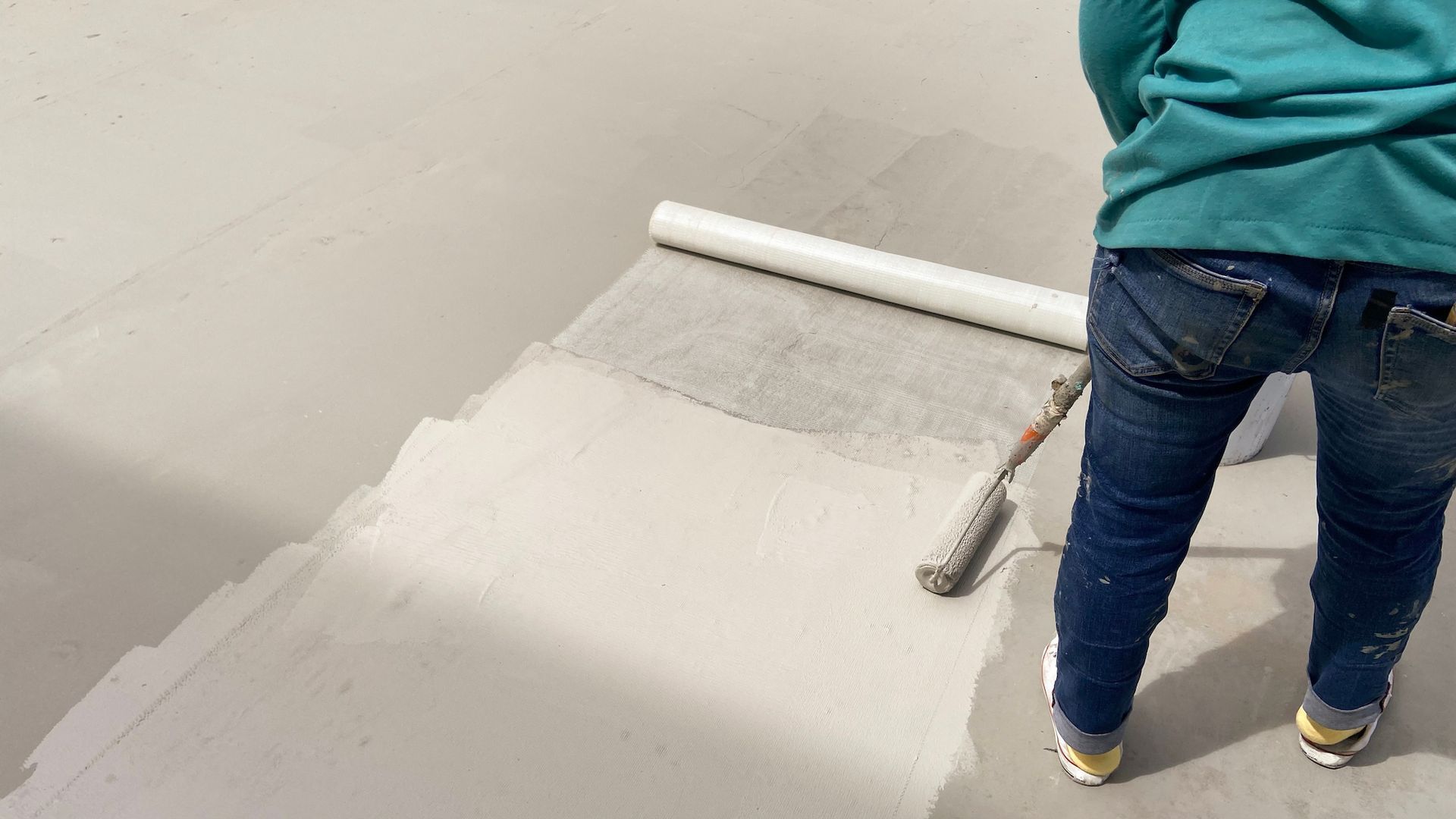 Person Applying a Sealant and Waterproof Membrane to the Surface — Consider It Sealed Waterproofing in Maitland, NSW