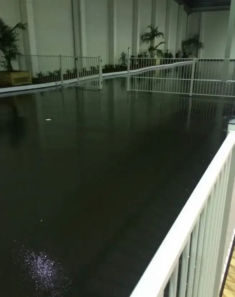 A Black Waterproof Membrane Surface With White Railings — Consider it Sealed Waterproofing in Crangan Bay, NSW