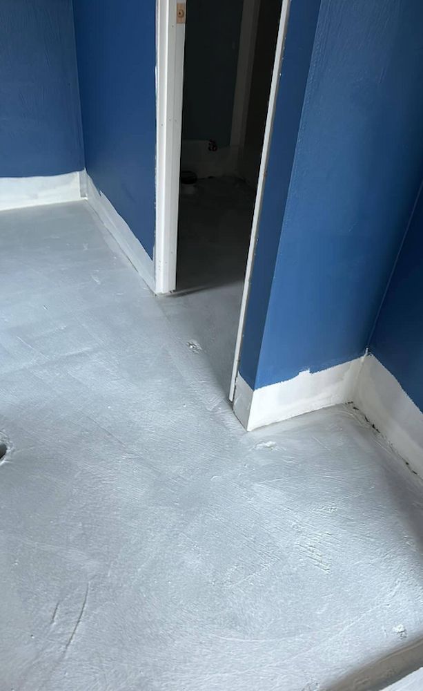A Room With Blue Walls and a Gray Floor — Consider it Sealed Waterproofing in Crangan Bay, NSW