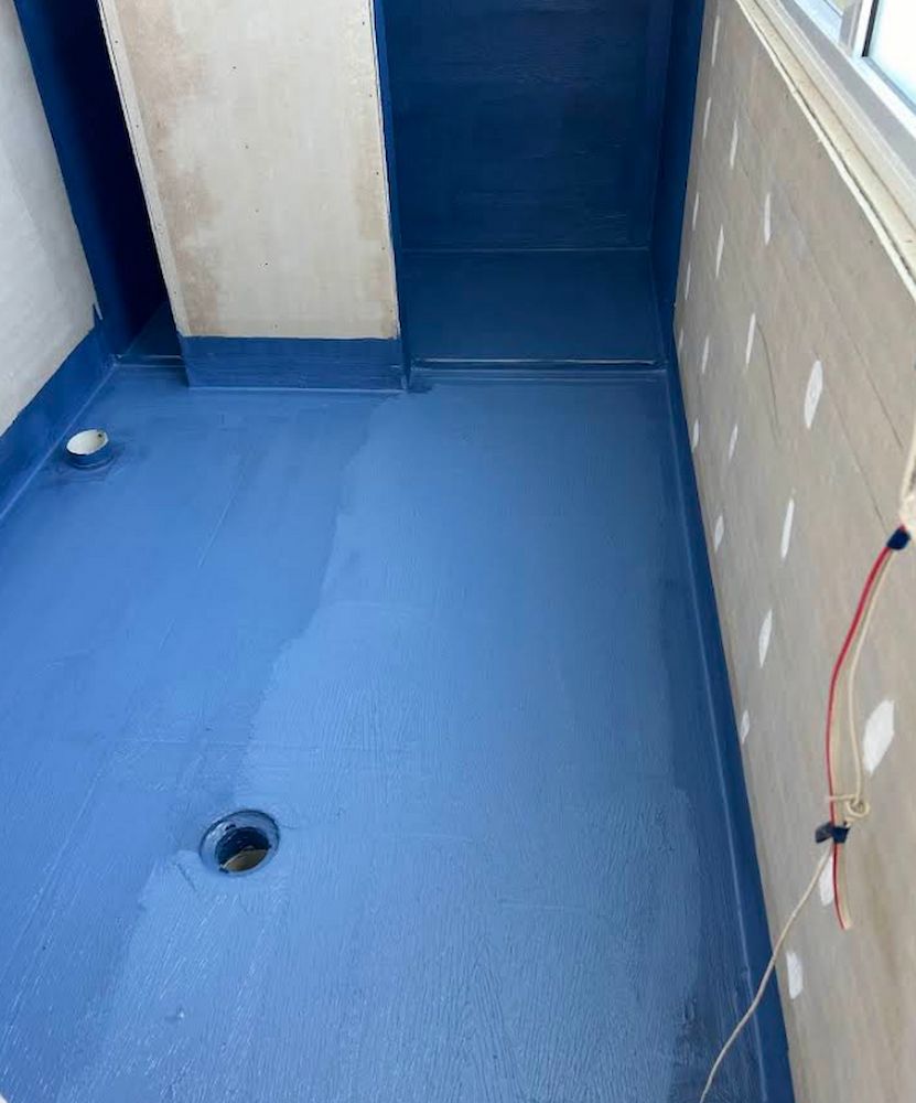 Blue Waterproof Coating Covers a Shower Floor and Walls — Consider it Sealed Waterproofing in Singleton, NSW