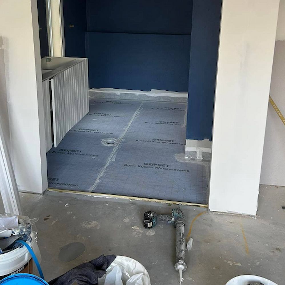 the Floor Has a Dark Waterproof Membrane Installed — Consider It Sealed Waterproofing in Newcastle, NSW