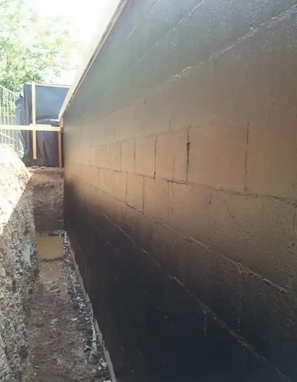 A Basement Wall Coated in Black Sealant — Consider It Sealed Waterproofing in Crangan Bay, NSW
