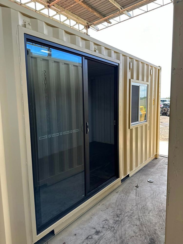 A Shipping Container With A Sliding Glass Door And A Window — Ries Trucking in Gowrie Mountain, QLD