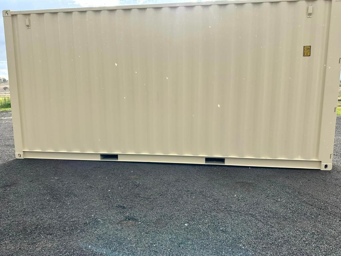 A Large Shipping Container Is Sitting On Top Of A Gravel Road — Ries Trucking in Gowrie Mountain, QLD