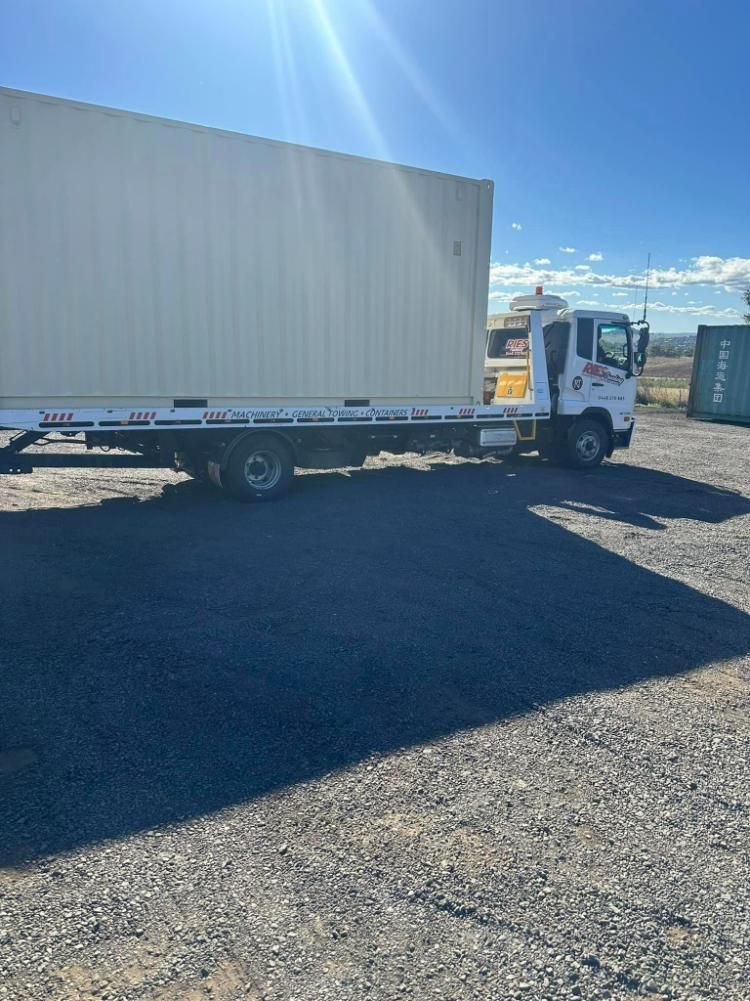 A White Tow Truck Is Parked In A Gravel Lot — Ries Trucking in Tara, QLD