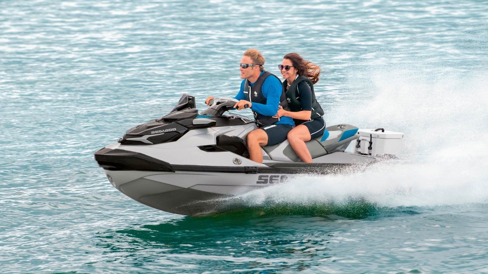 Man and woman riding on jet ski