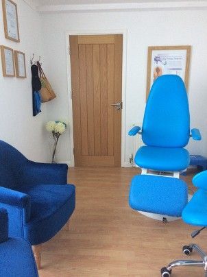 portrait photograph of podiatry treatment room with blue chairs