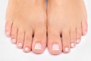 close up of person's toes with french manicure