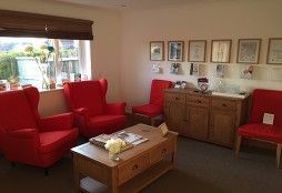 second view waiting room of a podiatry clinic with red armchairs