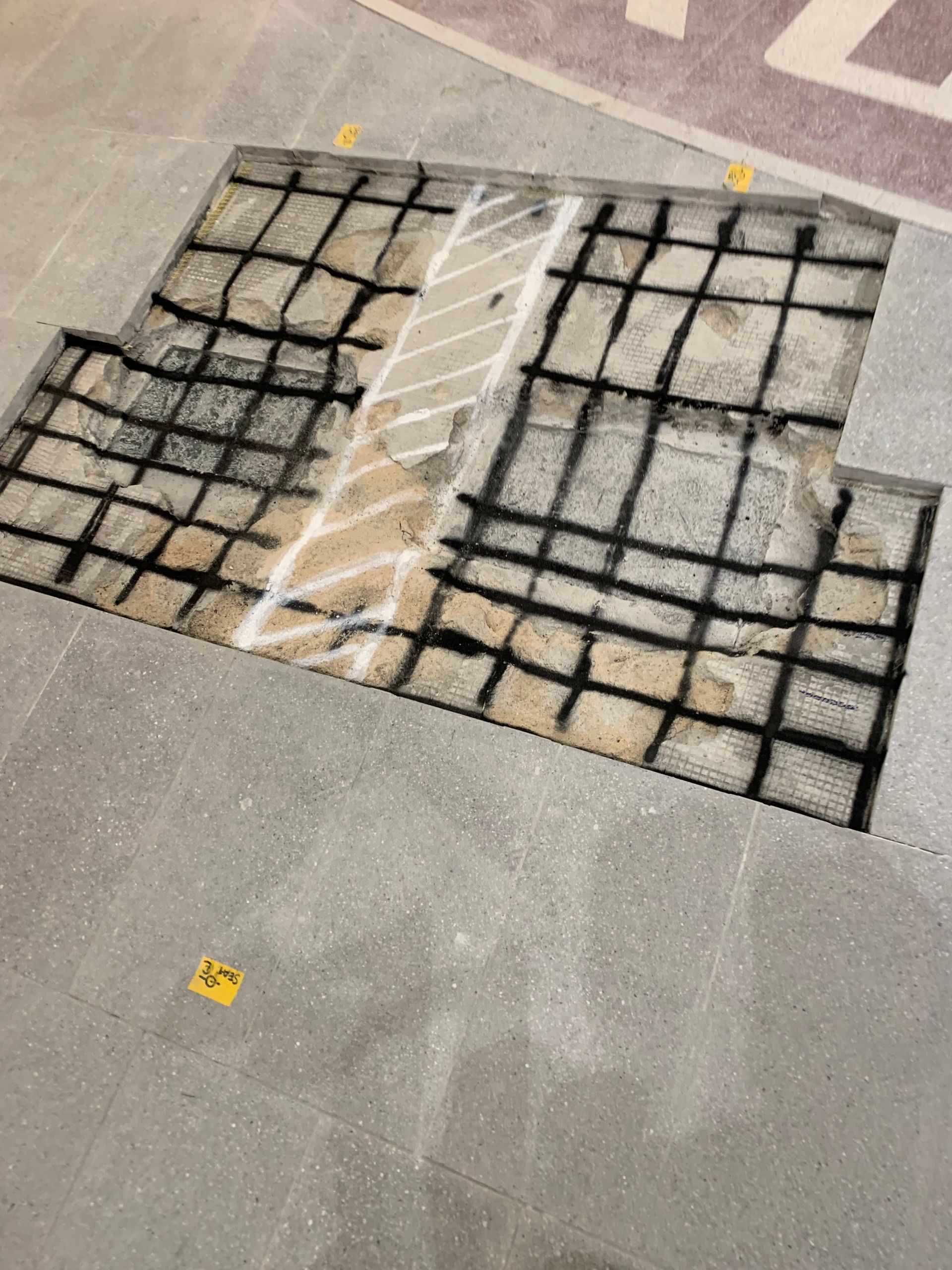 There is a hole in the floor that looks like a brick wall.