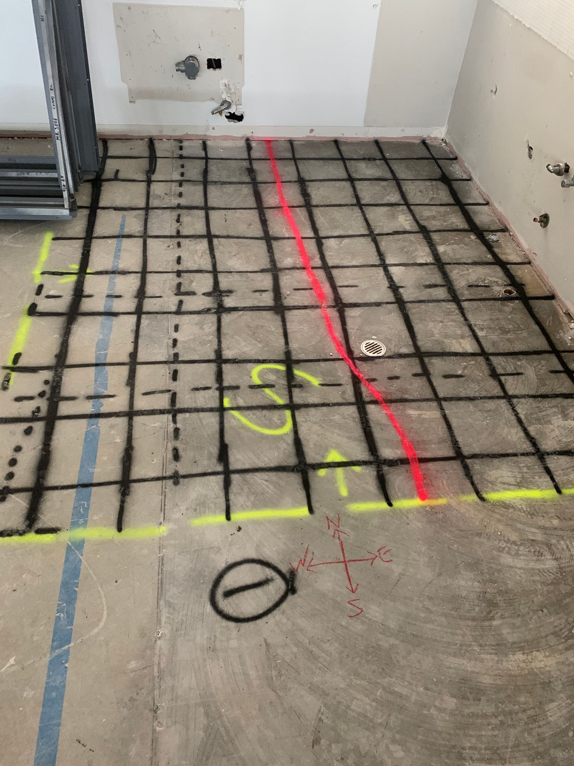 A concrete floor with a red line that says ' s ' on it