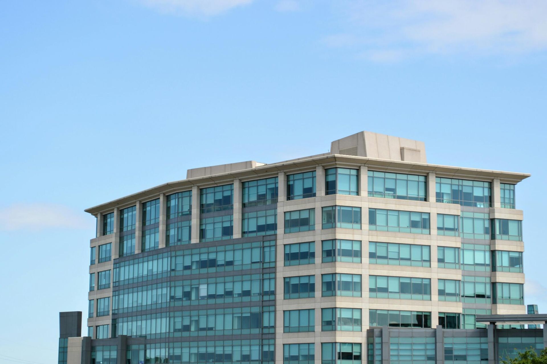 A large building with a lot of windows against a blue sky.