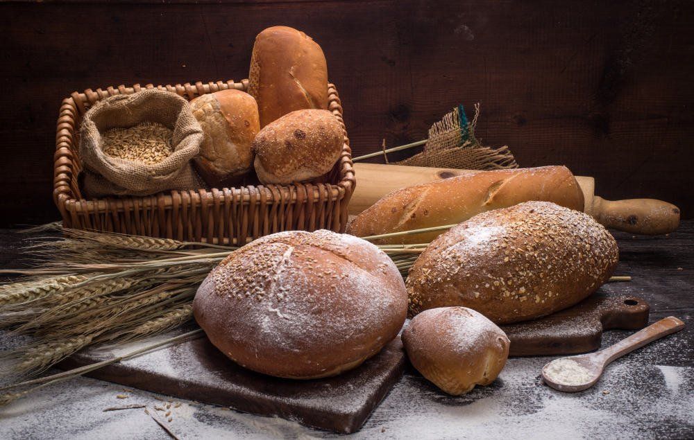 there are many different types of bread on the table .