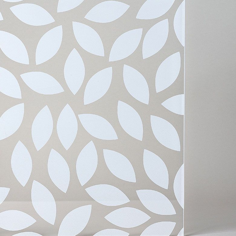 Beige background with white leaf pattern on glass.