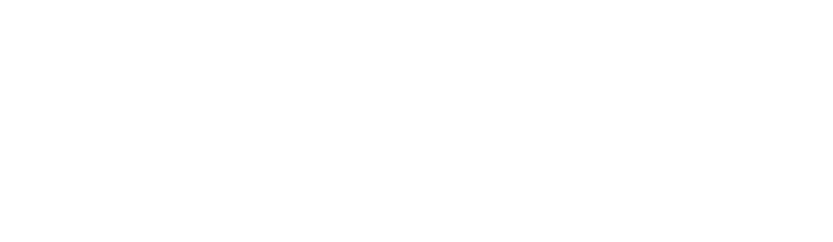 A group of people wearing blue shirts stand in a circle with their hands stacked in the center.