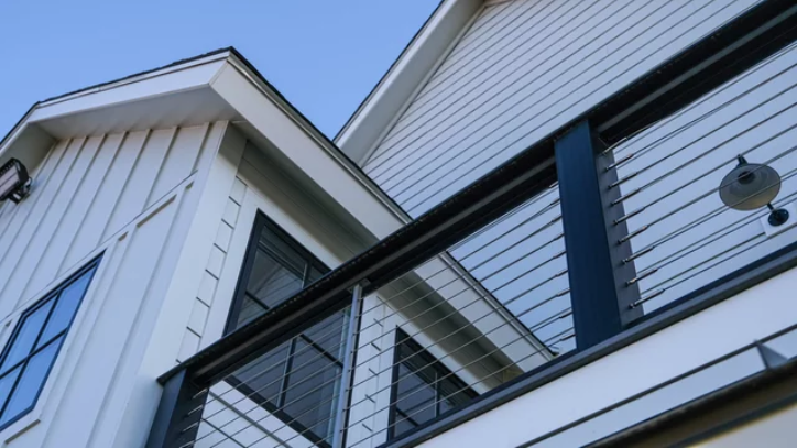 Exterior view of a modern farmhouse featuring James Hardie Fiber Cement siding.