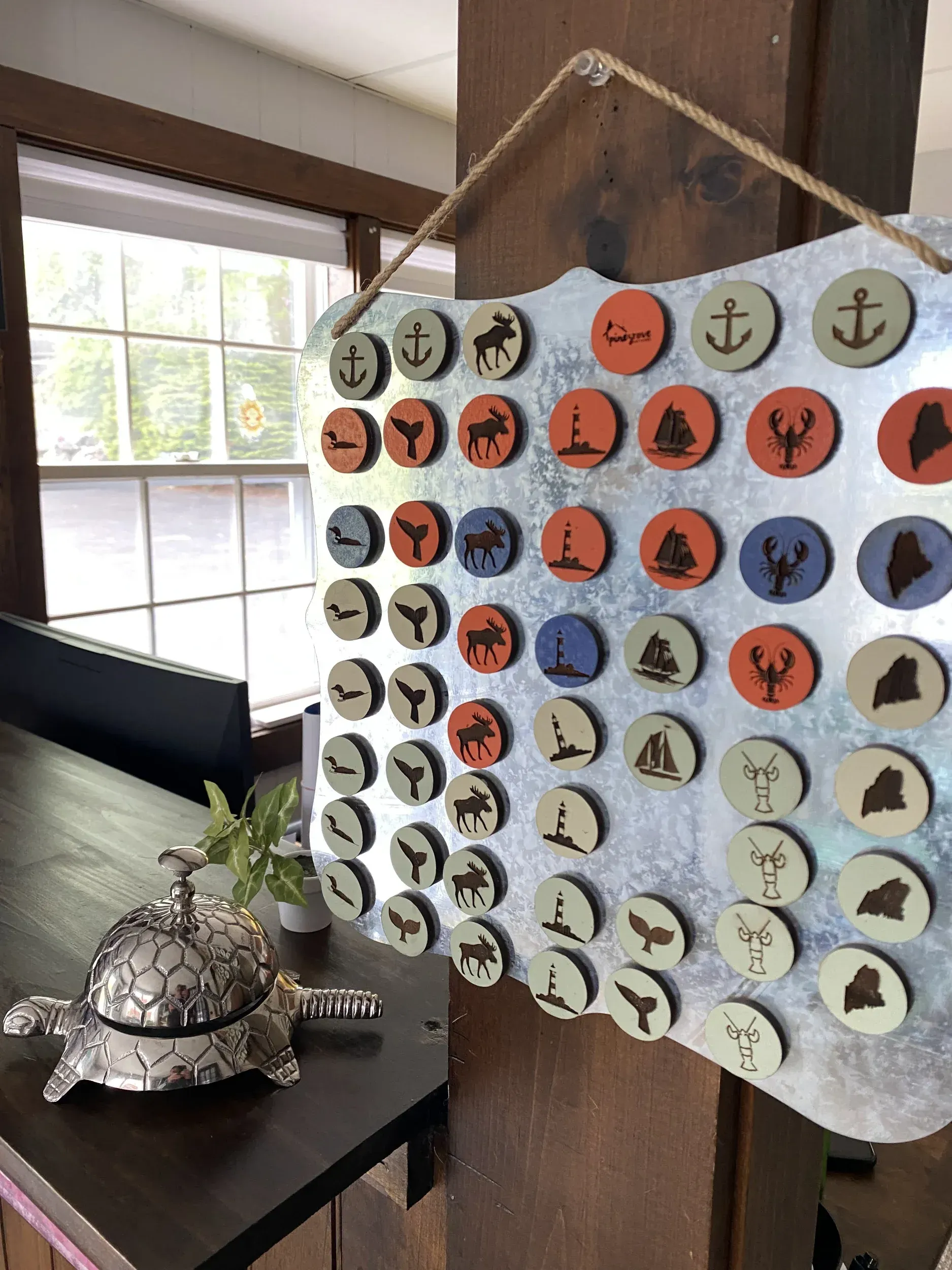 A table with a bell and a calendar hanging on a wall.