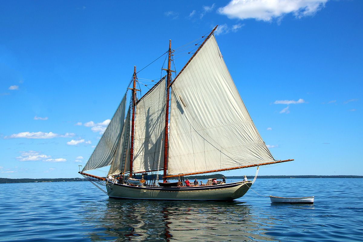 A sailboat is floating on top of a body of water.