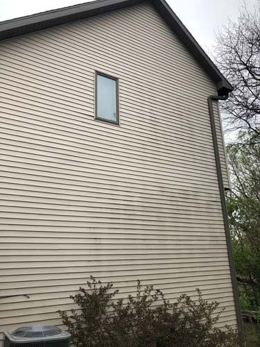 2 story taupe house with mildew staining