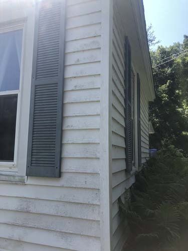 Corner of summer room requiring pressure washing