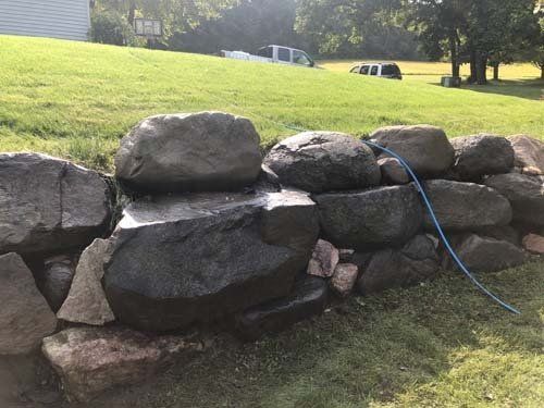 Cleaned and power washing rocks that are 3 ft tall in Madison Wisconsin