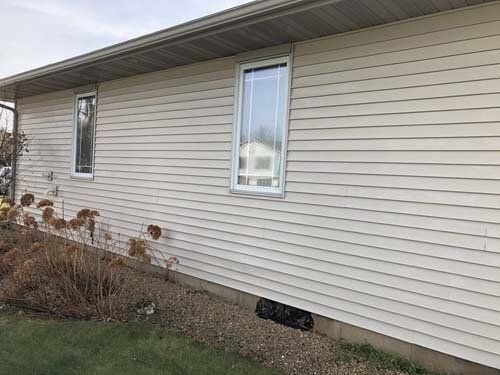 Photo of taupe home cleaned after power washing