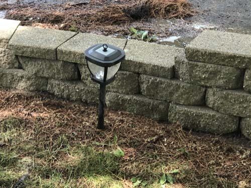 Cleaned, cleared and power washing bricks around residential siding