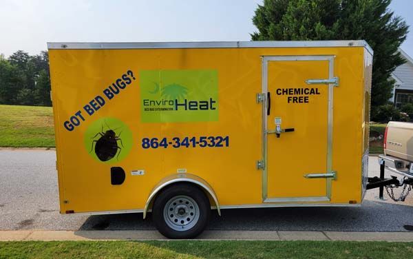 A yellow trailer that says got bed bugs on it.