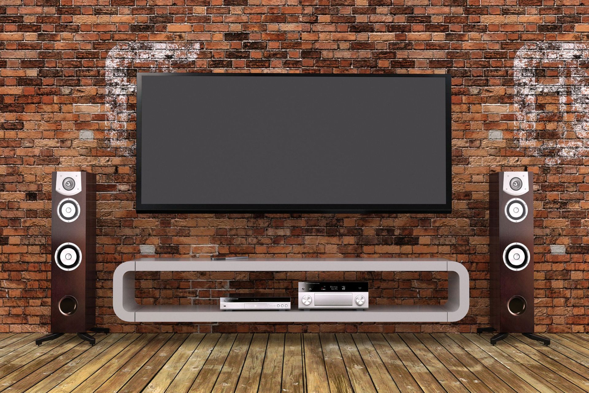 A flat screen tv is hanging on a brick wall next to two speakers.