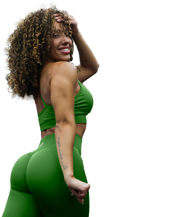 A woman with curly hair is wearing a green crop top and green leggings. Fit Era
