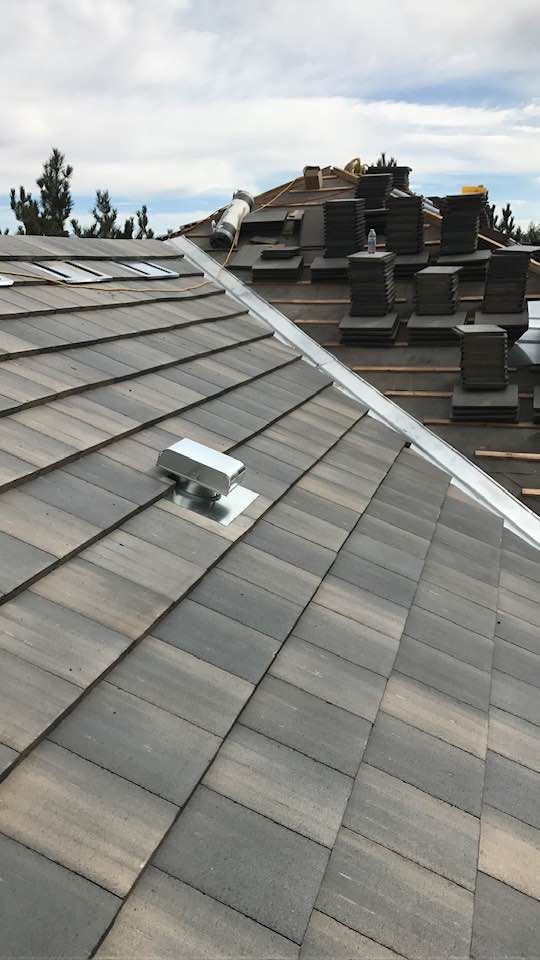 An aerial view of a snowy rooftop with a yellow stripe on it.