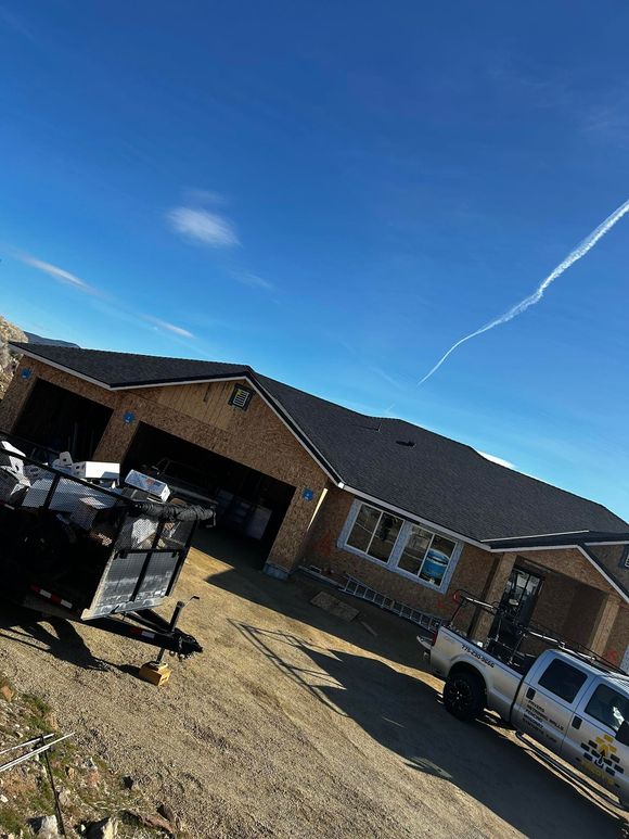 A truck is parked in front of a house.